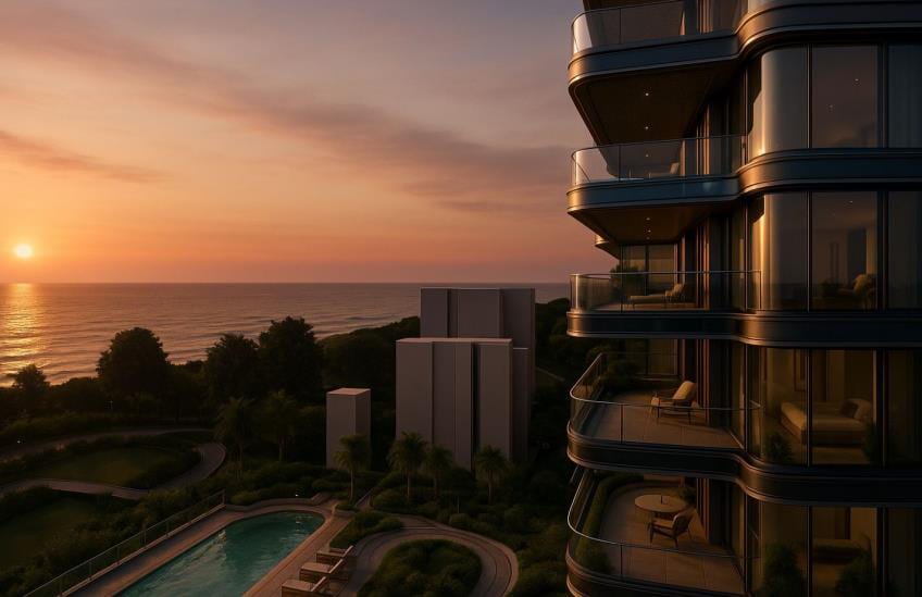 Dusk render of a sea-facing residential tower on Carter Road with stacked, deep-curved balconies.