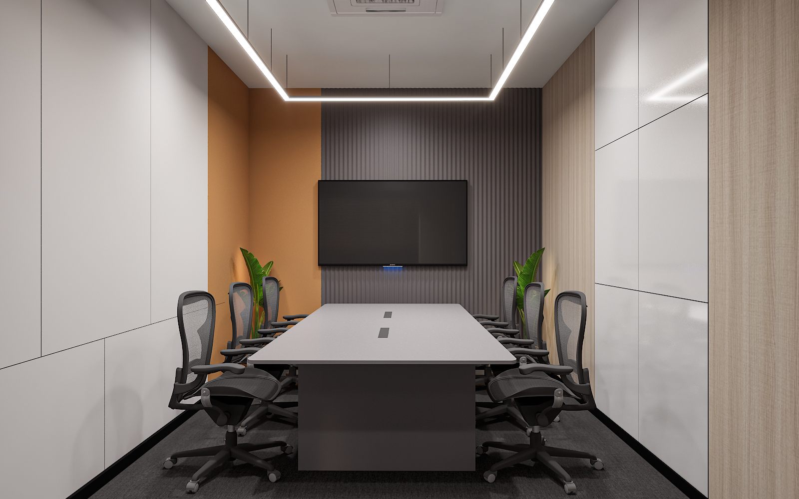 Small meeting room with a white boardroom table, black mesh chairs, wall-mounted screen on a grey fluted panel and an ochre accent wall on carpet flooring